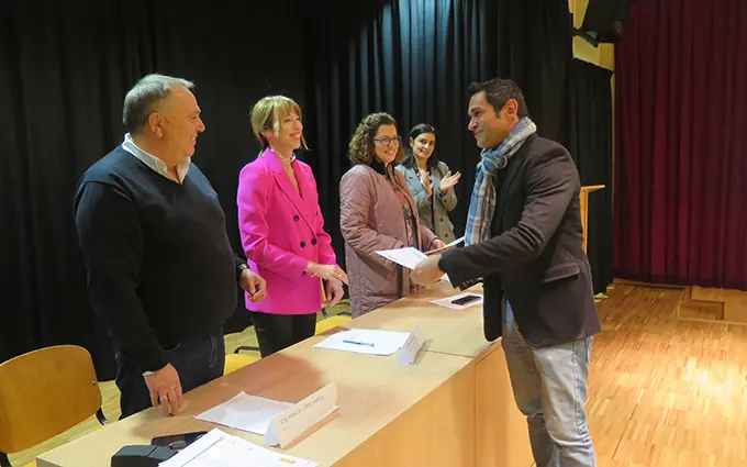 Unha das persoas do programa de emprego recibe o seu diploma